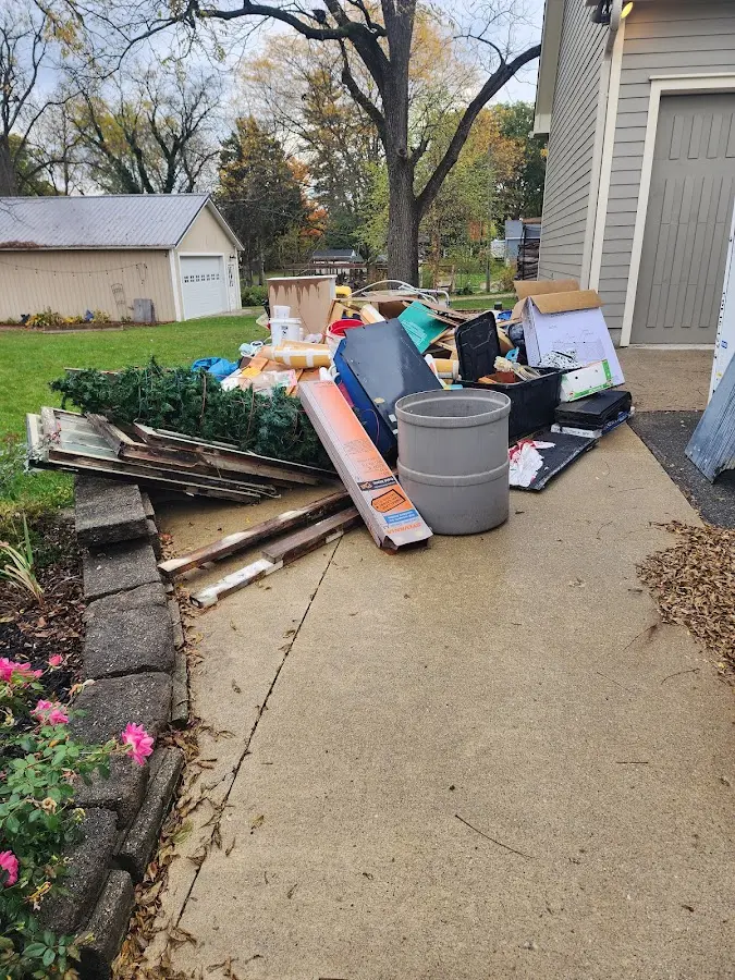Dumpster being loaded with debris for Roofing Dumpster Rental in Kalaeloa
